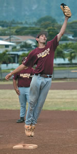 The Knights' pitcher/first baseman Bryan Raines (senior) reaches for the ball.