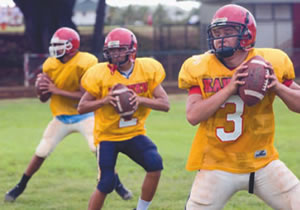Kahuku High players practice their passes during practice on the school field