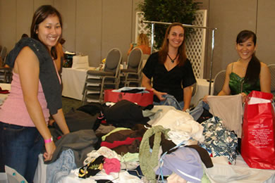 Volunteers Geri Itamoto, Heather Azevedo and Whitney Asao sort through the remaining piles of clothe