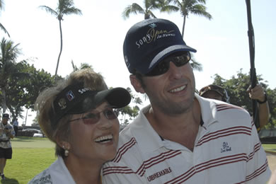 Tina Abernathy, a marshal at the Sony Open for the past nine years, shares a hug with Adam Sandler.