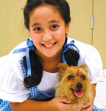 Chloe Amos and Ginny take on the classic roles of Dorothy and her dog Toto Oct. 14 in Oahu Arts Center’s Wizard of Oz. Photo from the arts center.