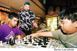 Chet Gionson helps Makaio Krienke and Kapena Lum