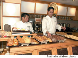 Rick Chang and Keoni Chang prepare platters of cookies and pastries