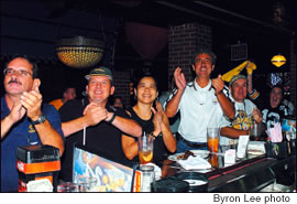 Frank Vehec, Jim and Maria Frishkorn, Carlino Giampolo, and Peter and Karen Eggers cheer on their team after a big play