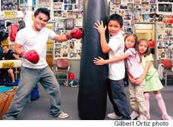 World champion Brian Viloria clowns around at the heavy bag with his nieces Loraine and Alyssa Diego and nephew Fredrick David
