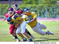 Cody Kekipi of Punahou (pictured here in the air) could play either offense or defense in college