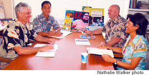 (from left) Bess Press publisher Benjamin “Buddy” Bess conducts a sales meeting with Ryan Nomi, Joel Cosseboom and Susan Cho