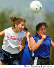 Rae Takenaka of Orange Crush battles two No Ack teammates for a header