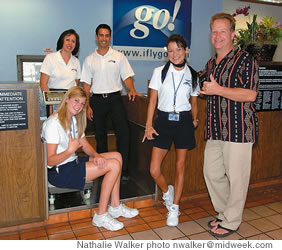 Ornstein at the check-in counter with, from left, Bette Brumlow, Tiffany Stuart, Joe Bock and Kea Young