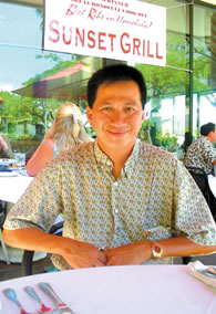 Sunset Grill owner Luong Nghiem Nguyen offers select wines by the glass during happy hour