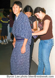 Luke Wadahara gets a hand with his yutaka from Christine Wadahara and Ariel Avilla