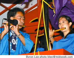 Guy Matsumoto and Cara Tsutsuse play flutes for the dancing