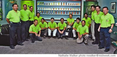 Really, it’s easy being green: The ITO EN Team at the Kalihi plant with their line of various teas displayed on the wall behind them