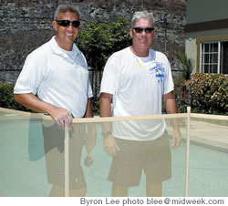 David Kahanu and Wes Maxwell install a safety fence around a pool