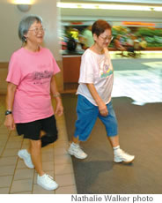 Gerry Young (left) and Mae Togo take a stroll in Kahala Mall