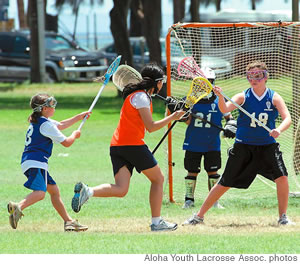 Janie Schaefer, Lauren Hennessy (with ball), Alexandra Haig (defender) and Sarah Berg (goalie)