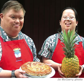 Brian Y. shows off a pineapple pie and Angie S. holds a pineapple grown on Helemano Plantation