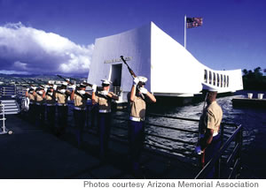 A Marine rifle detail fires a salute at the USS Arizona Memorial