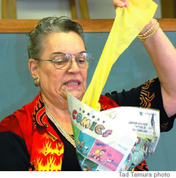 Magic Storyteller and member of the Hawaii Magicians Society, Yona Chock demonstrates how to magically pull colored paper from a newspaper cone