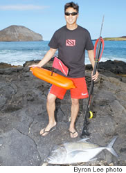Kevin Sakuda with his freedive float, spear gun and catch of the day