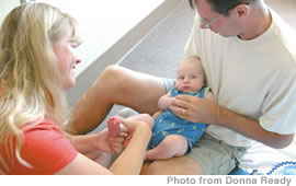 Donna and Derrik Ready massaging son Zachary at Queen’s Medical Center’s baby massage and exercise class