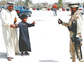 A U.S. soldier gets a thumbs up from an Iraqi boy