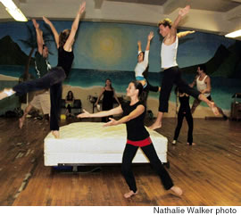IONA dancers rehearse a scene that includes bouncing on a bed.