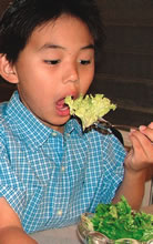Christopher Kaita chomps down on his salad greens
