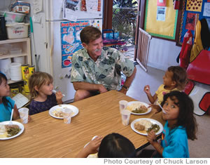 Fine Dining at Seagull School: Director Chuck Larson enjoys lunch with a few hungry students