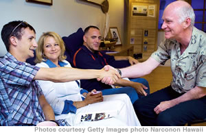 Chad Bloom, with mom Lari and Sgt. Al Palmere, receives congratulations from Clark Carr of Narconon Hawaii after successfully completing rehab