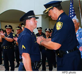 Chief Boisse Correa pins the HPD gold medal of valor on Officer Zane Hamrick’s uniform