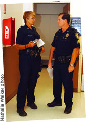 Officer Gay Minton and Hamrick discuss a burglary