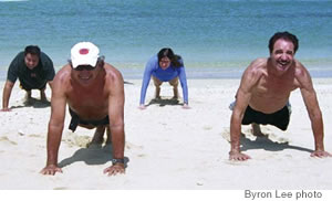 (from left) assistant Dustin Sharp, Kobelansky, Christine Radcliffe and Renard Jaques do push-ups to strengthen their upper body