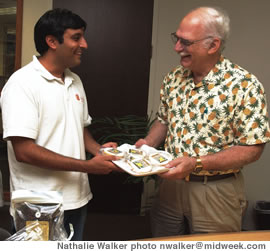 Dick Botti of HFIA (right) with Tushar Dubey of Hokulani Bakery and a tray of his cupcakes