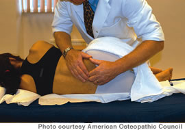 An osteopathic doctor manipulating a patient's spine