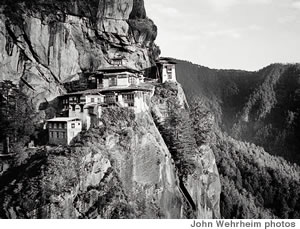 A village in Bhutan sits precariously on a mountain cliff