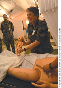 Maj. Laura Peterson delivers one of 10 babies 'born' in the exercise