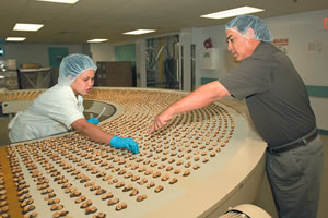 Tony Takitani tells Mely Pacheco about the old days of hand-dipping macadamia nuts