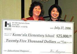 Haseko’s Sharene Saito Tam (right) presents a gift to Keone‘ula Elementary School principal Eileen Hirota. Photo from Haseko.