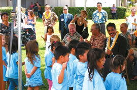 Children from the Pre-Plus program at Kapolei Elementary entertain a smiling Lt. Gov. Duke Aiona (right) and fellow attendees at the blessing of the new facility. Photo courtesy of the state Department of Human Services.