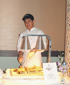 Zedrik Dana carves lamb racks for a special buffet at The Pearl, put on by students of Leeward Community College’s culinary arts program. Photo courtesy of The Pearl.