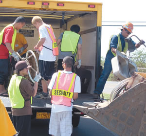 During the Feb. 17 recycling campaign by Kapolei High School students and Waste Management of Kapolei, Waste Management volunteers unload bulky items they collected from neighborhood homes.